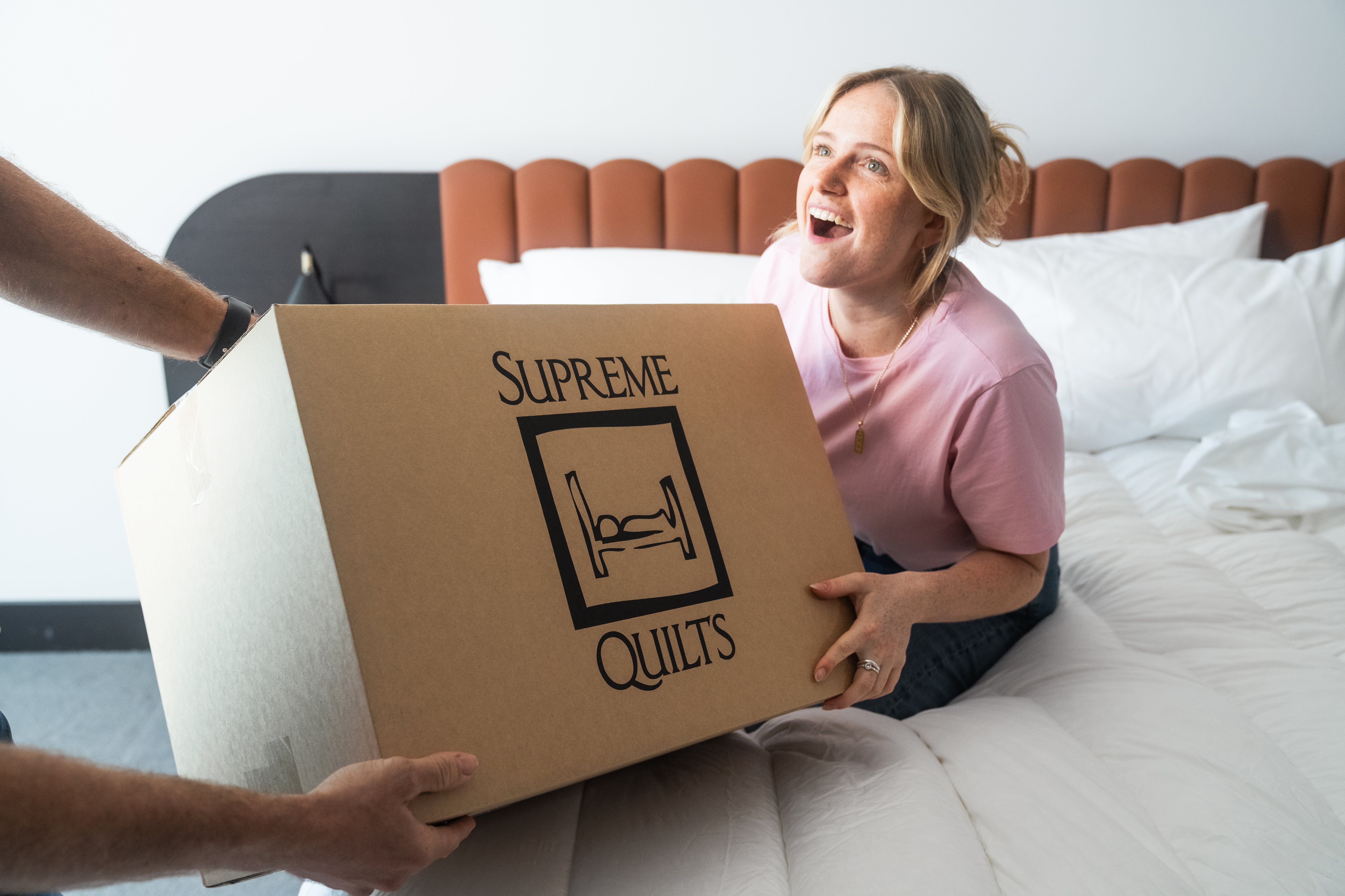 Elegantly layered Supreme Quilts white down quilt adding plush softness and calming warmth to a peaceful bedroom retreat.