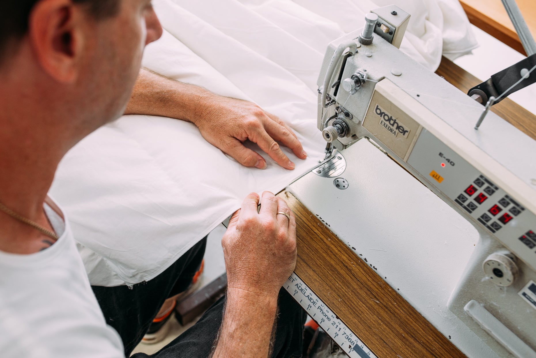 Owner of Supreme Quilts Australia Stitching together a Premium Goose and Duck Down duvet, blanket, quilt, pillow, and mattress topper using a sewing machine. Handmade in Australia and ethically sourced duck and goose down from Europe
