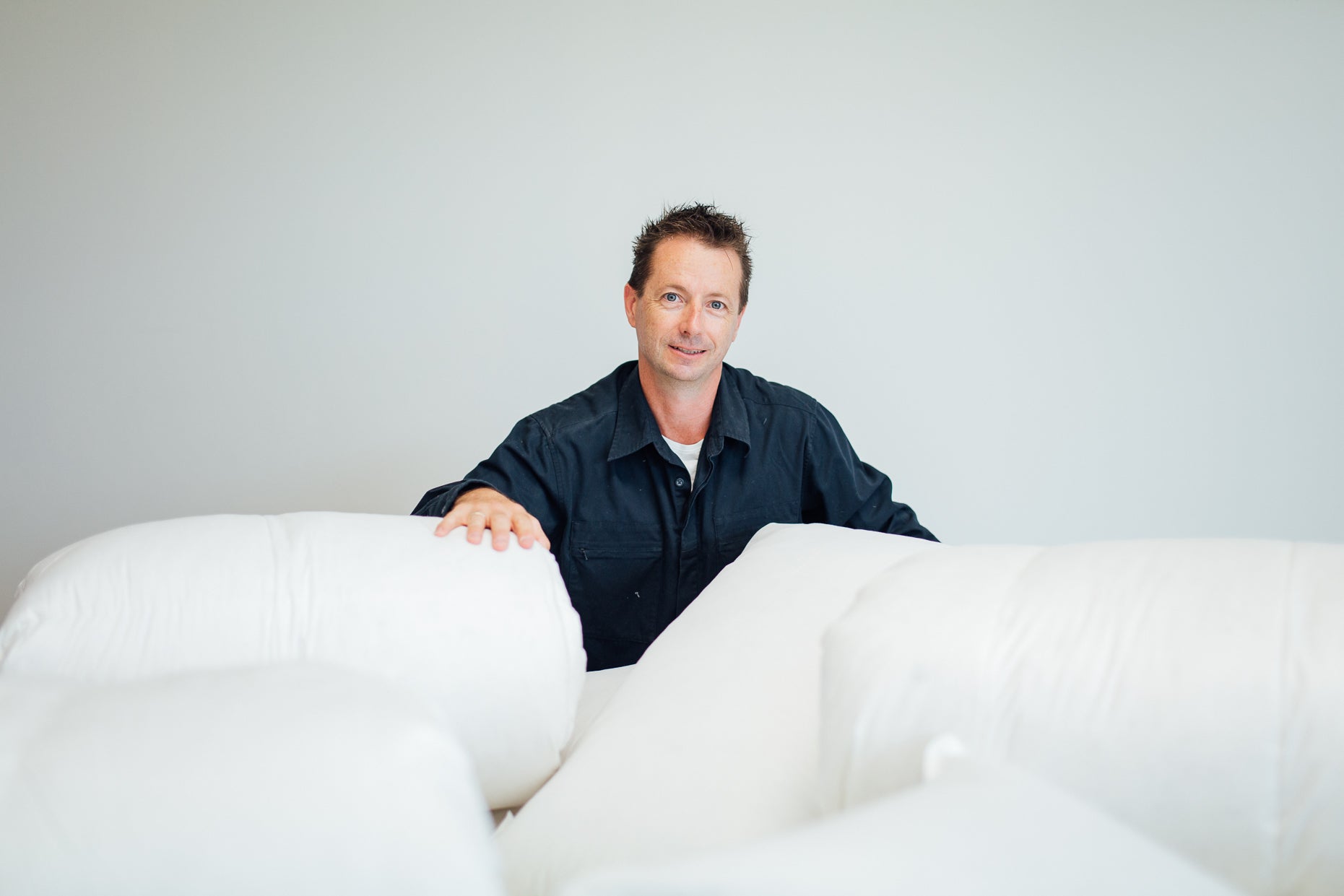 Owner of Supreme Quilts Standing in front of European Duck and Goose Down Quilts, Duvets, Blankets, Pillows, and Mattress Toppers Made in Australia